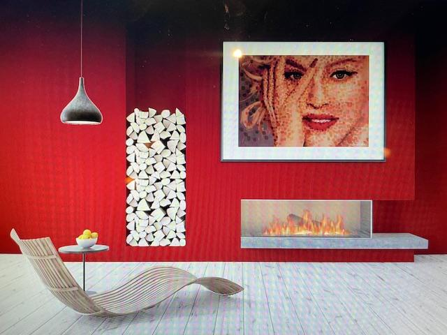 Framed pop-art portrait hung above a fireplace in a modern living room